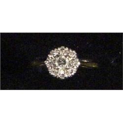 18ct gold lady's ring set with a + ct central diamond and six outer diamonds