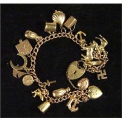 9ct gold charm bracelet set with approximately 20 assorted gold charms