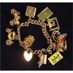 9ct gold charm bracelet with ten assorted charms including matador, My Fair Lady, carriage, car, cas