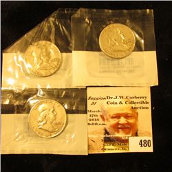 1957 D, 58 D, & 60 D Franklin Half Dollars, all in Littleton Coin Company cellophane holders.