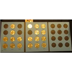1986-1987 Partial Set of Kennedy Half Dollars in a blue Whitman coin folder. (19 pcs.) Most are BU.