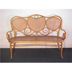 Thonet Furniture, BENTWOOD SETTEE, with cane back and seat (small patch areas), round and flat...