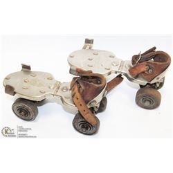 SET OF EARLY SUNSHINE ROLLER SKATES.