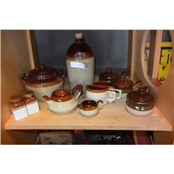 SHELF LOT OF POTTERY SERVING PIECES AND DISPENSER