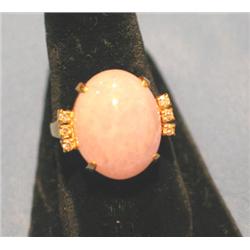 RING W/PINKISH CENTER STONE SURROUNDED BY (6) DIAMONDS