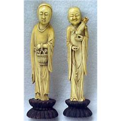 A pair of carved ivory Japanese figures on wo
