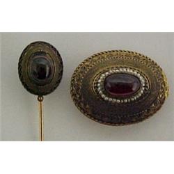 Two garnet pins, 1 1/8" wide oval pin with ca