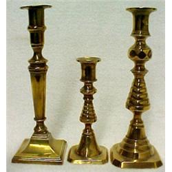 Three brass candlesticks, all with flared rim