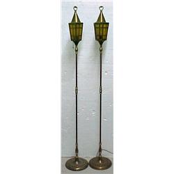 A pair of brass torchieres, loop finials on c