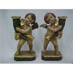 A pair of Austrian painted wooden cherub cand