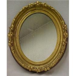 Oval gilt framed mirror, berry and leaf decor
