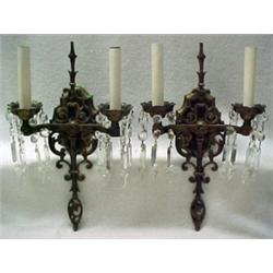A pair of brass sconces, two arms, cut glass
