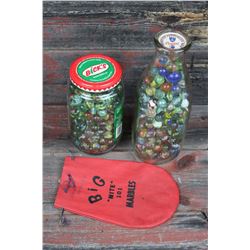 Jar And Milk Bottle Full Of Marbles And Marble Bag