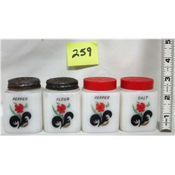 Set of 4 vintage milk glass range shakers. Floral logo.