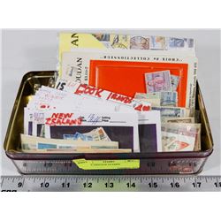 TIN OF VINTAGE STAMPS.