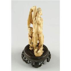 Lot# 69  FINE ANTIQUE IVORY CARVING OF A MAN AND BOY WITH FISH.  