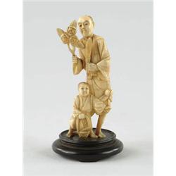 Lot# 70  ANTIQUE CARVED ORIENTAL IVORY OF MAN AND BOY.  