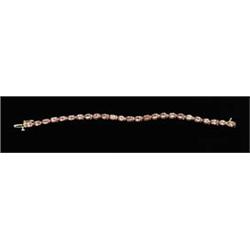 Lot# 289  14K YELLOW GOLD AND RUSSIAN RASPBERRY SPINEL TENNIS BRACELET.  