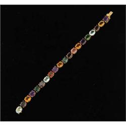 Lot# 312  18K YELLOW GOLD MULTI-GEM TENNIS BRACELET.  