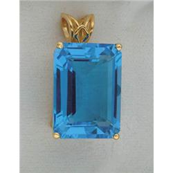 Lot# 321  14K YELLOW GOLD AND SWISS BLUE TOPAZ PENDANT.  