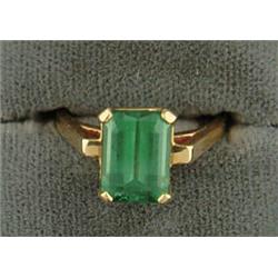 Lot# 322  14K YELLOW GOLD AND SYNTHETIC EMERALD RING.  