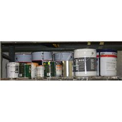 SHELF OF EMPTY METAL PAILS AND PAINT CANS