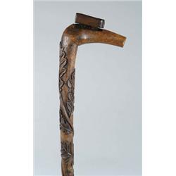 Lot #  634:  CANE: CARVED WOOD CANE.