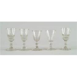 Lot #  1100:  LOT OF FIVE EARLY KNOBBED CLEAR WINE GLASSES.