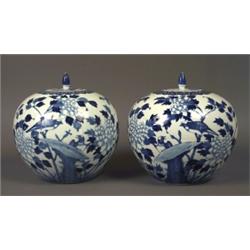 A pair of urns with lids