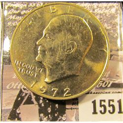 1551 . 1972 P Eisenhower Dollar, Gem BU with light gold toning.