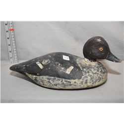 Antique hand carved and hand painted duck decoy with glass eyes, lead weighted base and leather teth