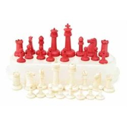 A 19th century Staunton pattern ivory chess set, half stained in red, king 3ins...