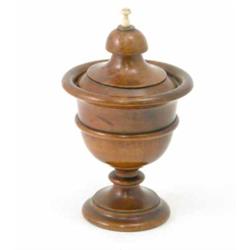 A turned yew cup and cover, with ivory finial on circular stepped base, 8.5ins...
