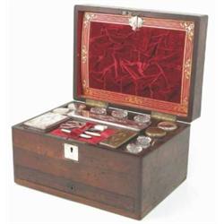 A 19th century rosewood toilet box, with mother-of-pearl inlaid medallions, the hinged lid enclos...