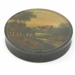 A 19th century black lacquered papier mache round box, decorated with a finely painted pastoral s...