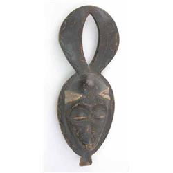 An early 20th century Bakwele carved wood mask, lower Congo region, with animal horn crest, 22.5...