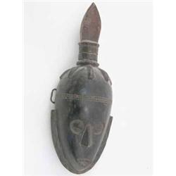 An early 20th century Baule carved wood mask, Ivory Coast, with stylized flame crest, 18.5 ins...