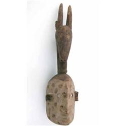 A Dogon carved wood mask, Mali, with animal crest and decorated with pigments, 22 ins...