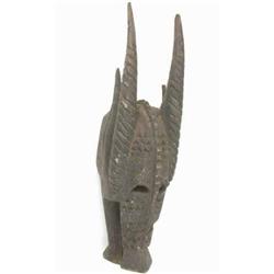 A Senufo carved wood mask, Ivory Coast, profusely carved in the form of a stylized animal head, 2...