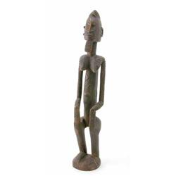 A Dogon carved wood female figure, Mali, modelled with a child on her back and geometric detailin...