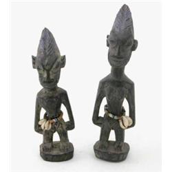 Two Yoruba Ere Ibeji carved wood male figures, with mauve highlights and adorned with trade beads...