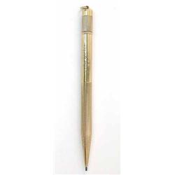 A 9ct gold propelling pencil, with twist action ring top and machine turned decoration, 4.5ins...