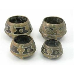 Four Middle-Eastern design brass mounted wooden pots, of various sizes and with similar applied b...
