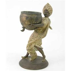 L. Hottot, an Orientalist spelter figure of a boy carrying a pot, naturalistically modelled in ar...