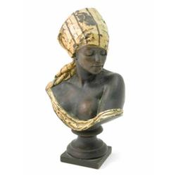 A French copper and composition Nubian bust, modelled wearing a headdress with cold painted decor...