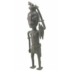 A cast bronze Ibo hunter, Nigeria, modelled with dead game and weapons, 16.5 ins...