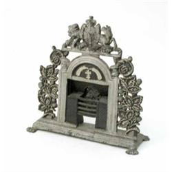 A cast iron door stop, in the form of a fire place, painted silver and surmounted with a coat of...