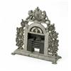 Image 1 : A cast iron door stop, in the form of a fire place, painted silver and surmounted with a coat of...