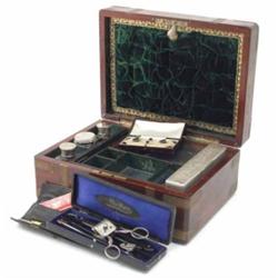 A brass mounted mahogany toilet box, the hinged lid enclosing a compartmented interior with four...