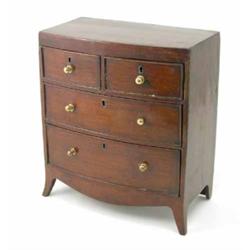 A 19th century miniature mahogany bow front chest of drawers, with two short and two long drawers...